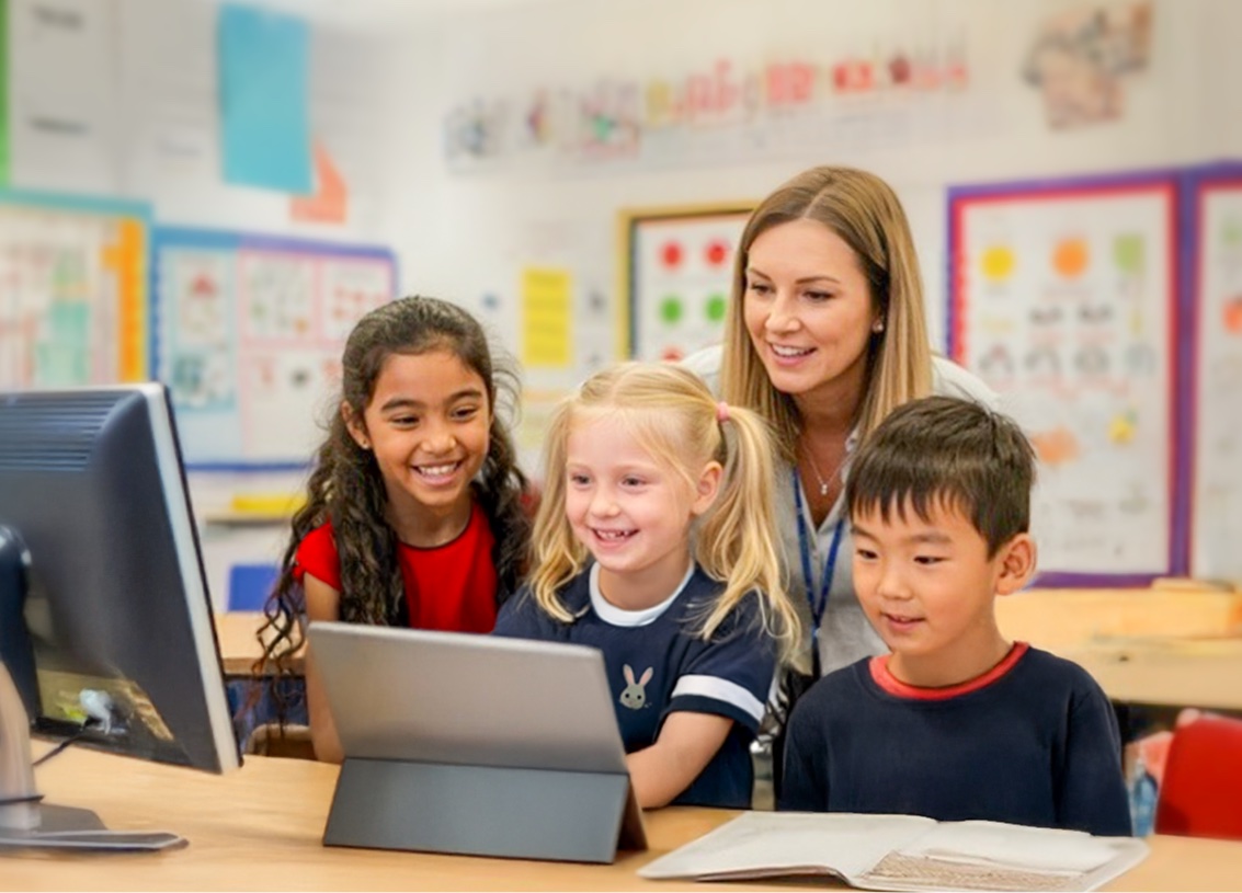 female teahcer is using Reading Eggs with a group of students in the classroom.